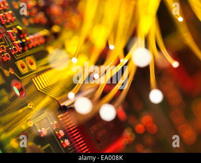 Fibre optics carrying data passing a circuit board Stock Photo