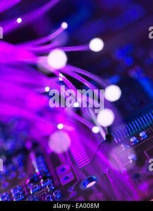 Close up of fibre optics carrying data passing a circuit board Stock Photo