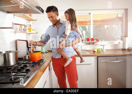 Father and daughter cooking in kitchen Stock Photo