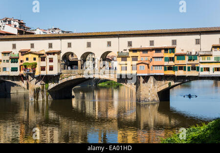 Florence, Florence Province, Tuscany, Italy.  Sculler passing under the Ponte Vecchio, or Old Bridge, on the Arno River. Stock Photo