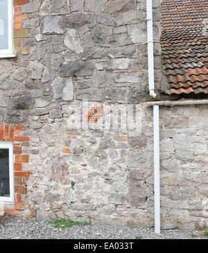 Mis matched stone wall detail of an old stone building in the Somerset village of Cheddar, November 2014 Stock Photo