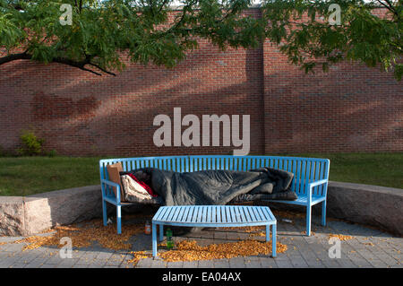 Homeless black man sleeping on a park bench New York City New York ...