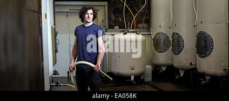 Portrait of a brewery worker in his working environment Stock Photo