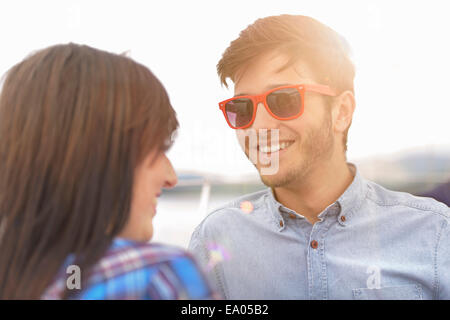 Young couple smiling on yacht during sunset Stock Photo