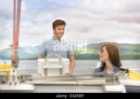 Young couple sailing on yacht over lake Stock Photo