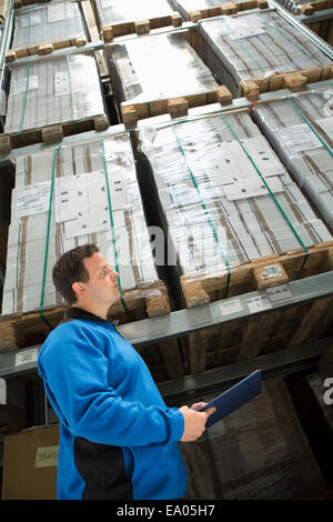 Factory worker checking pallets Stock Photo