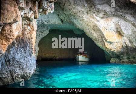 Tourist boat in the Blue Grotto sea caves in Malta Stock Photo