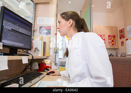Pharmacist in pharmacy using desktop computer Stock Photo