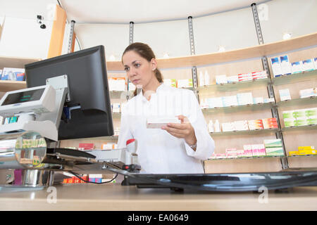 Pharmacist in pharmacy using computer Stock Photo