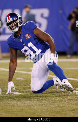 New York Giants' Eli Manning tries to get away from Denver Broncos' Robert  Ayers at MetLife Stadium in East Rutherford, New Jersey, Sunday, September  15, 2013. (Photo by Tyson Trish/The Record/MCT/Sipa USA