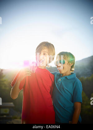Two brothers making faces for selfie on smartphone, Majorca, Spain Stock Photo