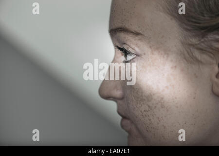 Side view of young woman with freckles Stock Photo