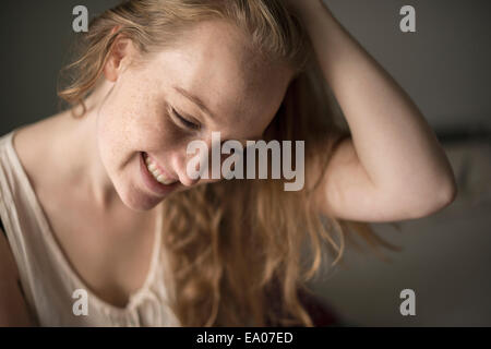 Portrait of young woman with freckles laughing Stock Photo