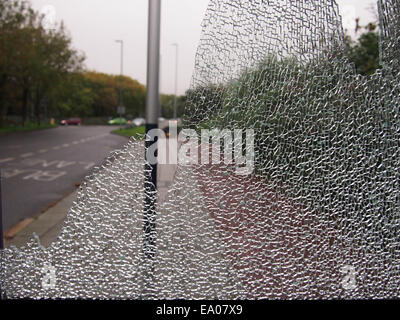 close up of a broken window pane in a bus shelter Stock Photo