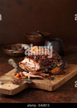 Christmas dinner. Slow roasted spiced apricot & cranberry lamb with roasted red onions Stock Photo