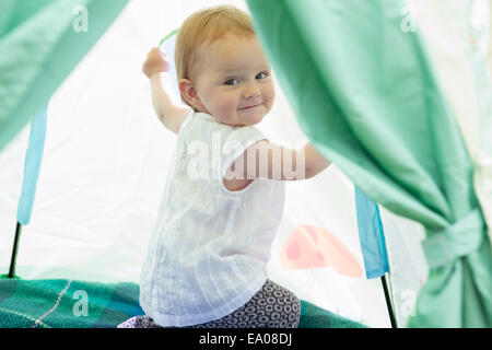 Baby girl playing in tent Stock Photo