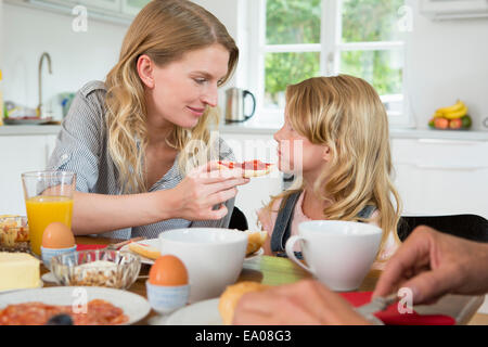 Caucasian mother offering daughter healthy food Stock Photo - Alamy