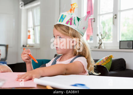 Girl wearing homemade paper crown Stock Photo