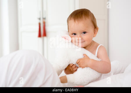 Baby girl holding soft toy Stock Photo