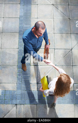 Businessman and business woman shaking hands Stock Photo
