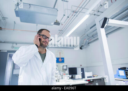 Lab assistant using smartphone Stock Photo
