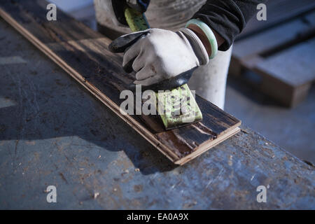 Carpenter working on wood plank in factory, Jiangsu, China