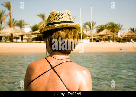 Woman sunning by seaside, Sharm El Sheikh, Egypt Stock Photo