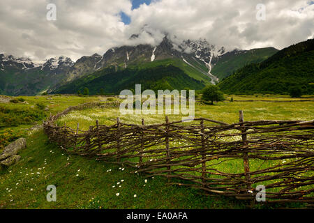 Hand woven fence and distant mountains, Mazeri village, Svaneti, Georgia Stock Photo