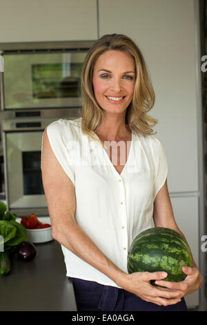 Mature woman holding watermelon