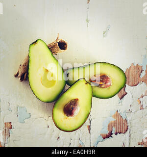 Fresh avocado on wooden rusty background. Instagram color effect. Stock Photo