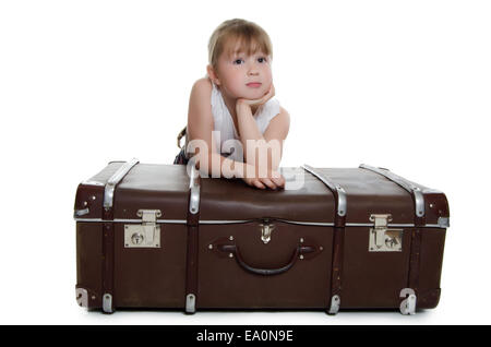 The little girl on old suitcases Stock Photo