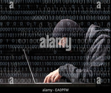 Computer hacker in a balaclava Stock Photo