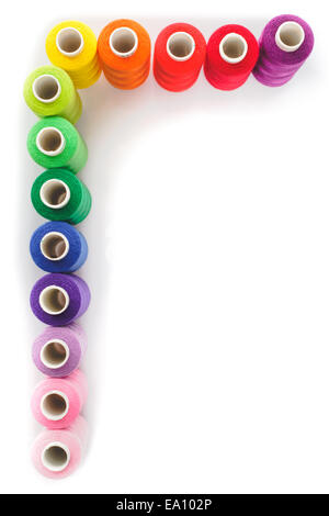 Sewing multicolored  threads isolated on a white background Stock Photo