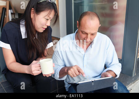 Two architect colleagues using at digital tablet on office step Stock Photo