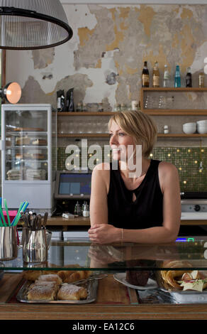 Mid adult woman working in cafe Stock Photo