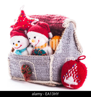 Two knitted christmas  snowmen in a house and handmade christmas tree Stock Photo