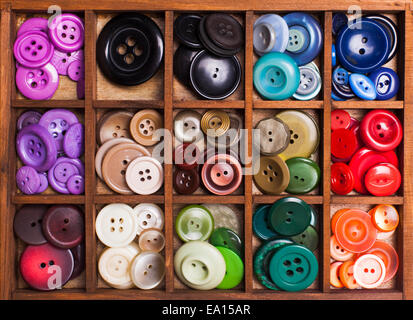 Colorful buttons in a wooden box for design Stock Photo