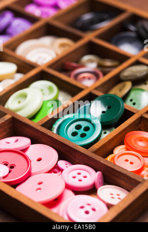 Colorful buttons in a wooden box for design Stock Photo