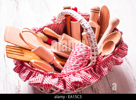 Shabby chic rustic basket with wooden kitchen utensils Stock Photo