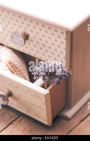 Bunch of dry lavender in decorative little shabby chic chest of drawers Stock Photo