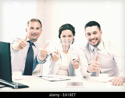 business team showing thumbs up in office Stock Photo