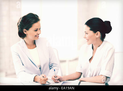 two businesswomen having discussion in office Stock Photo