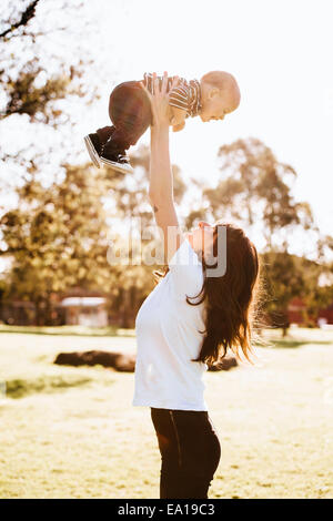 Mother swinging son in air Stock Photo