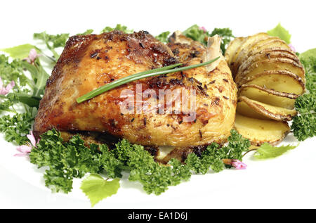 Fried chicken thighs  with roast potatoes hasselback Stock Photo