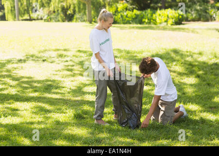 Volunteers picking up litter in park Stock Photo