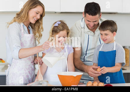 Family making cookies together in kitchen Stock Photo