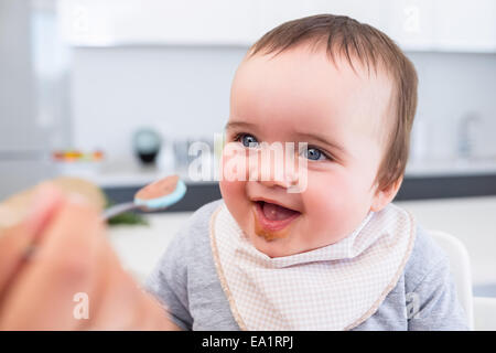 Baby boy being fed by mother Stock Photo