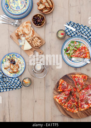 outdoor dining table set with pizza Stock Photo
