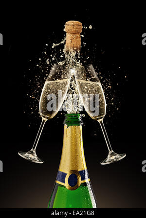Celebration theme. Glasses and bottle of champagne with bubbles, isolated on black background Stock Photo