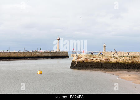 Whitby harbour looking over to West and East piers, North Yorkshire, England Stock Photo